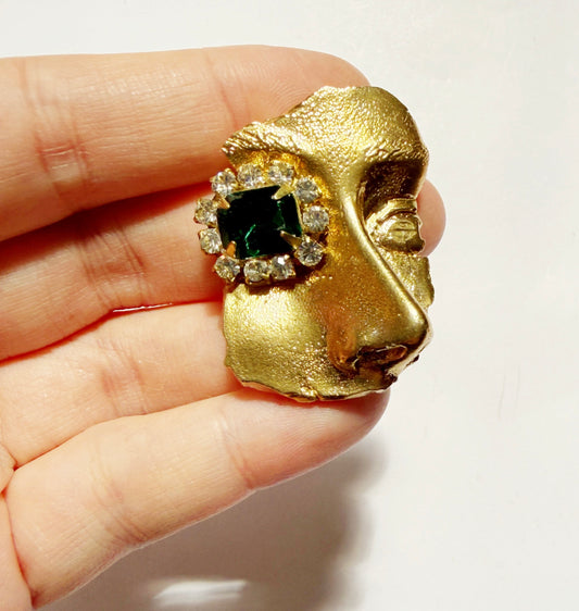 Gilded artifact face brooch