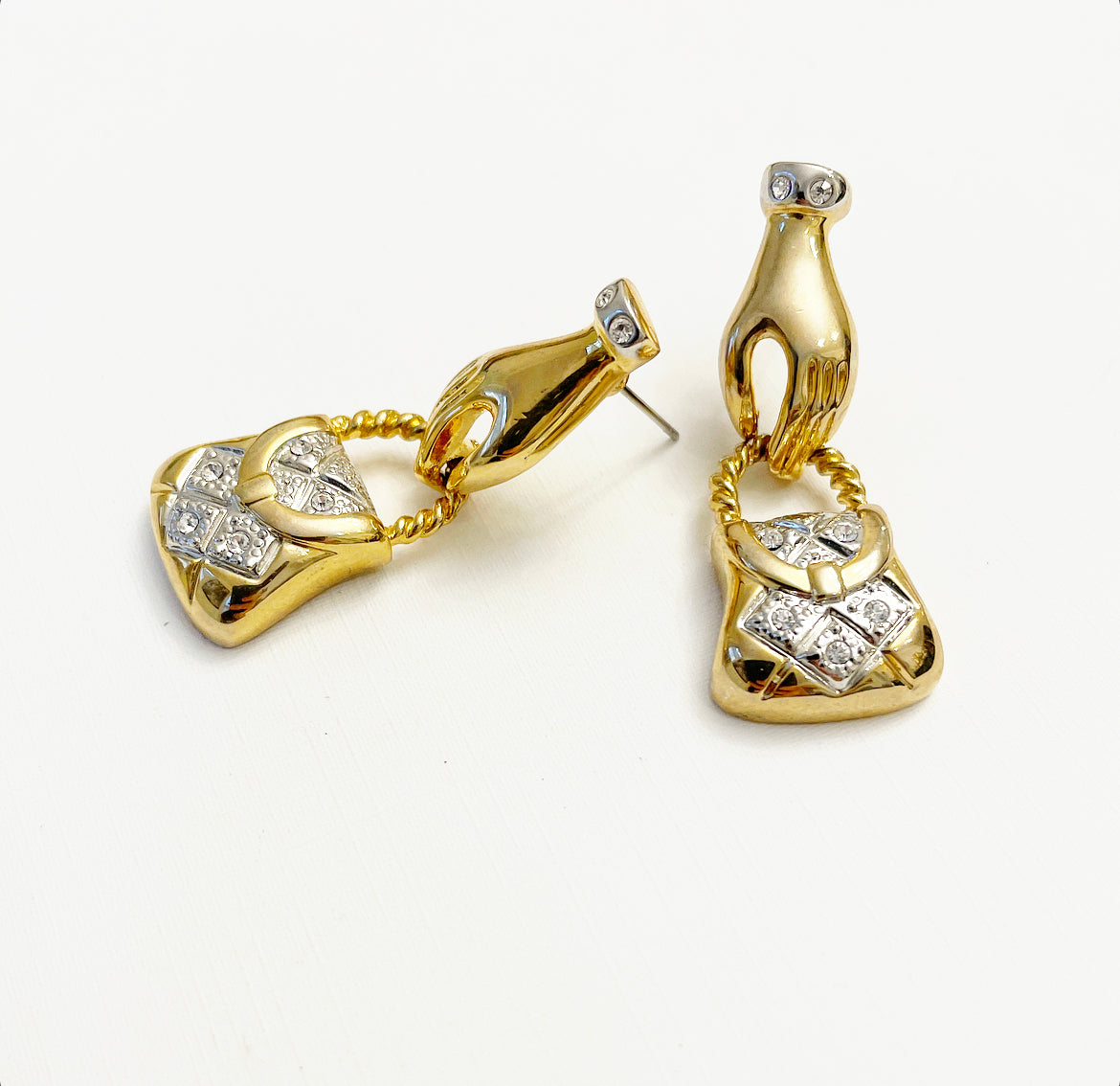 Vintage hand holding purse earrings