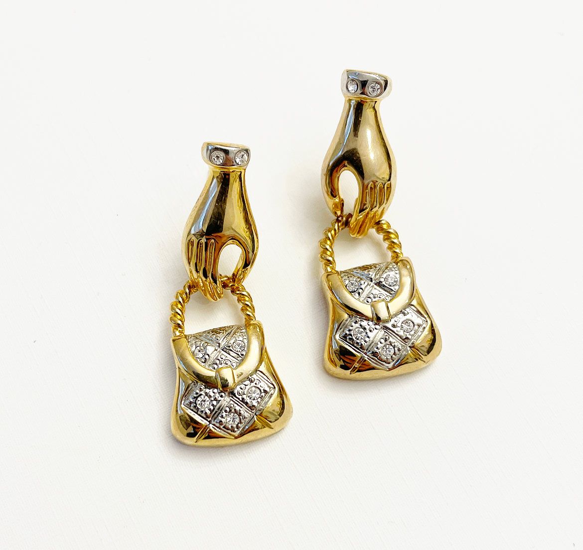 Vintage hand holding purse earrings
