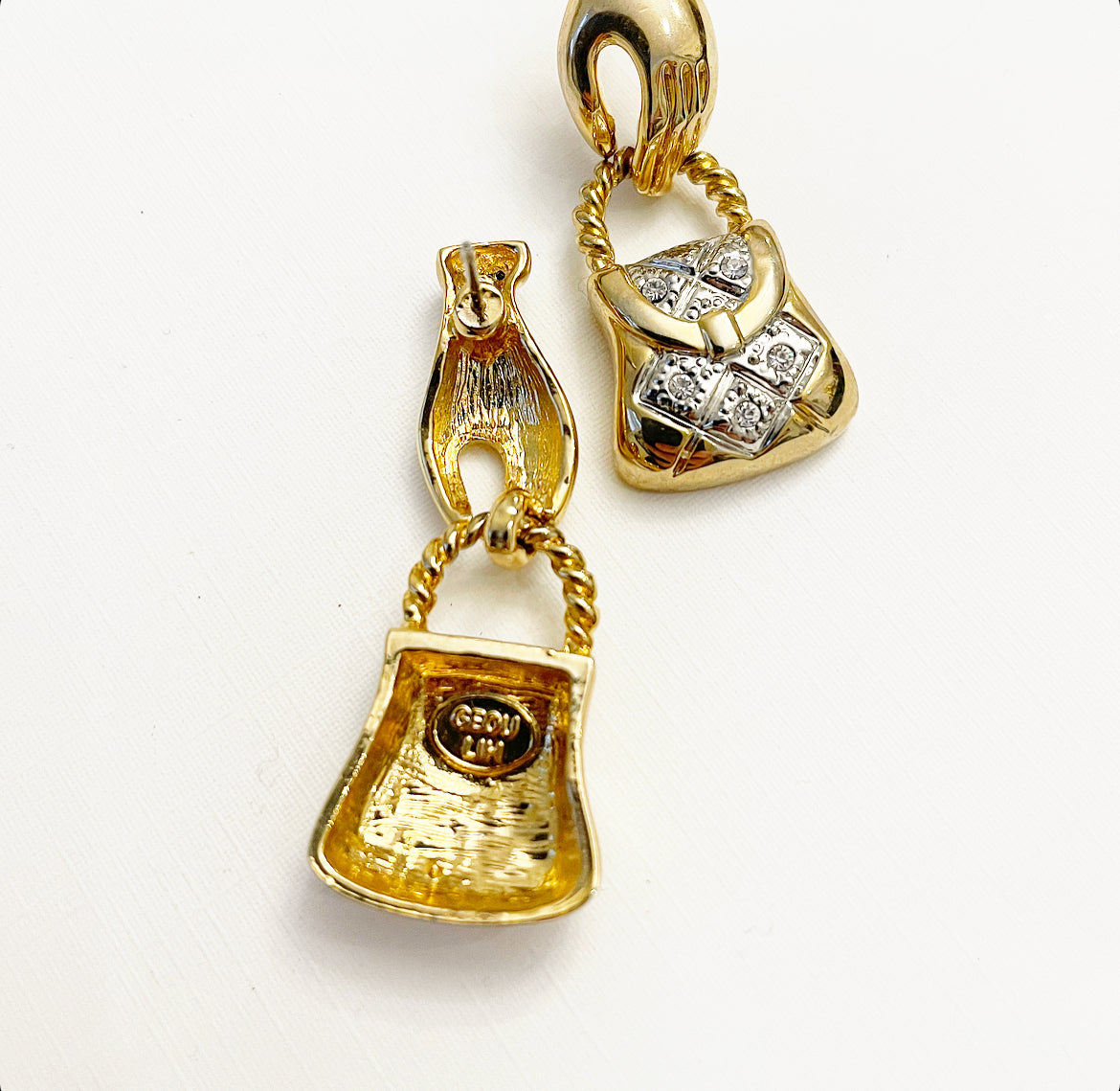 Vintage hand holding purse earrings