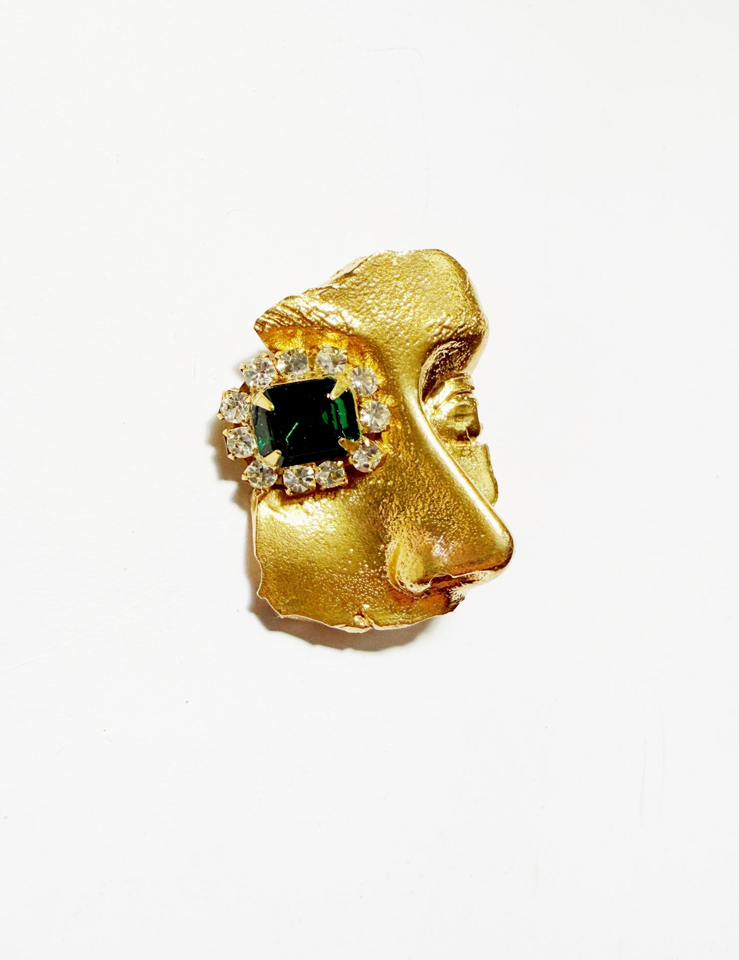 Gilded artifact face brooch