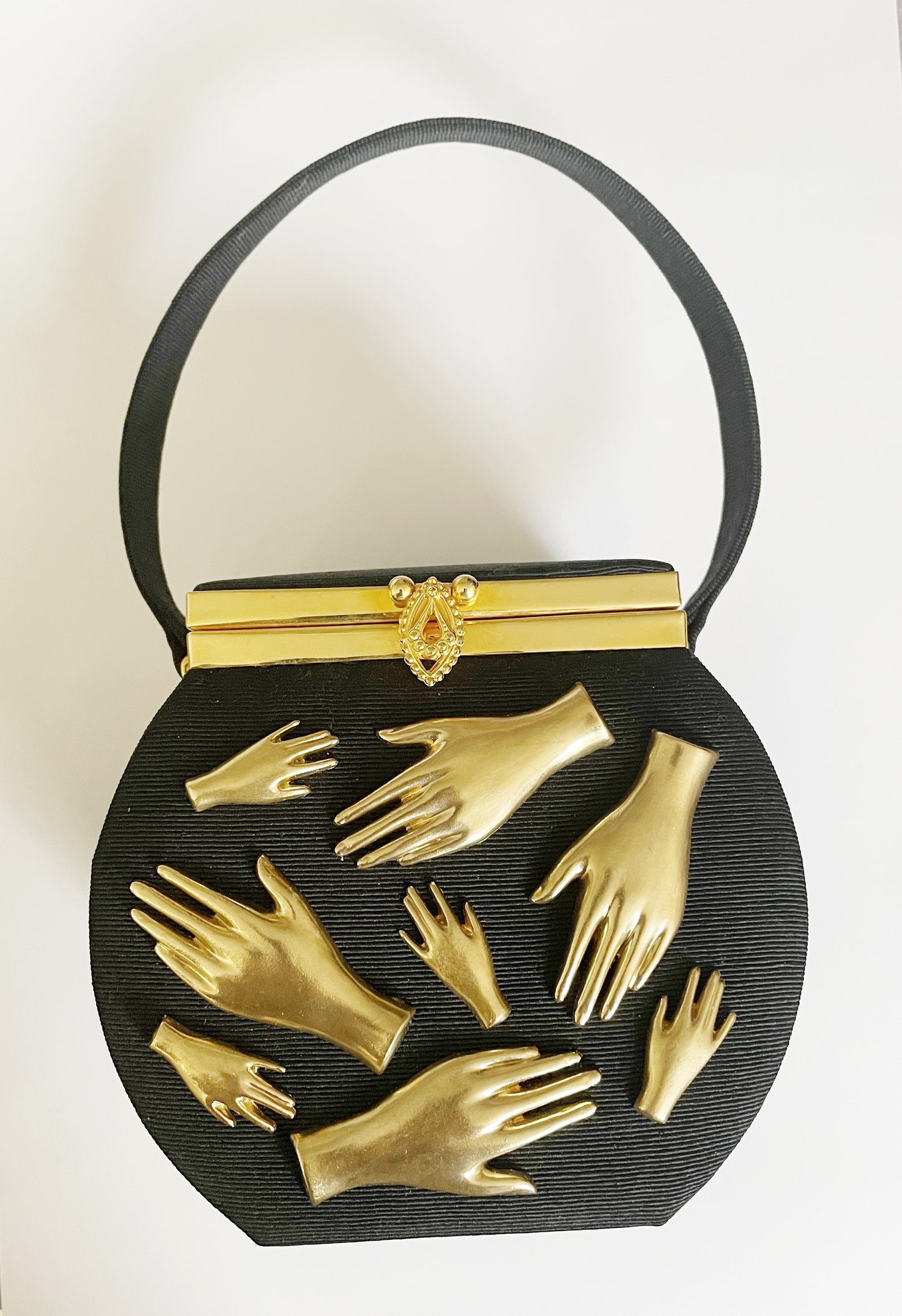 gallery wall hands in purse