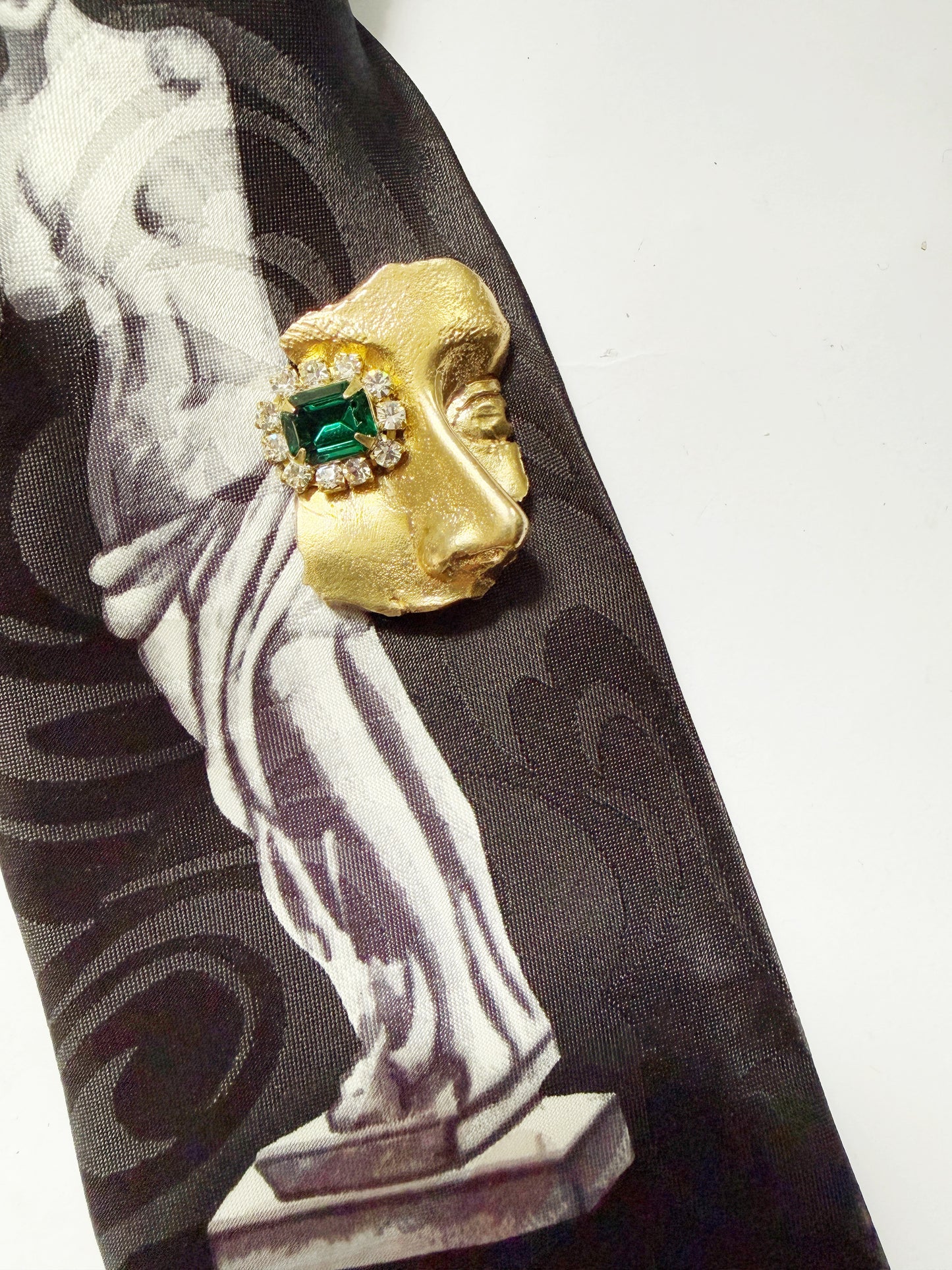Gilded artifact face brooch