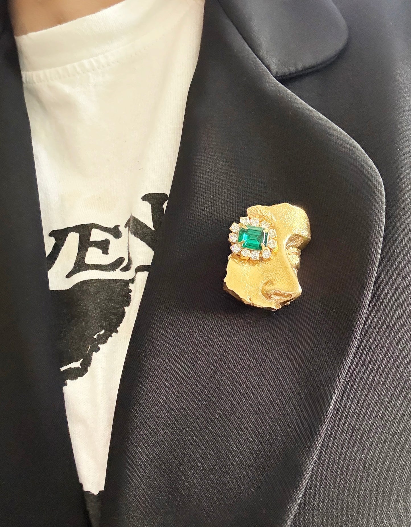 Gilded artifact face brooch