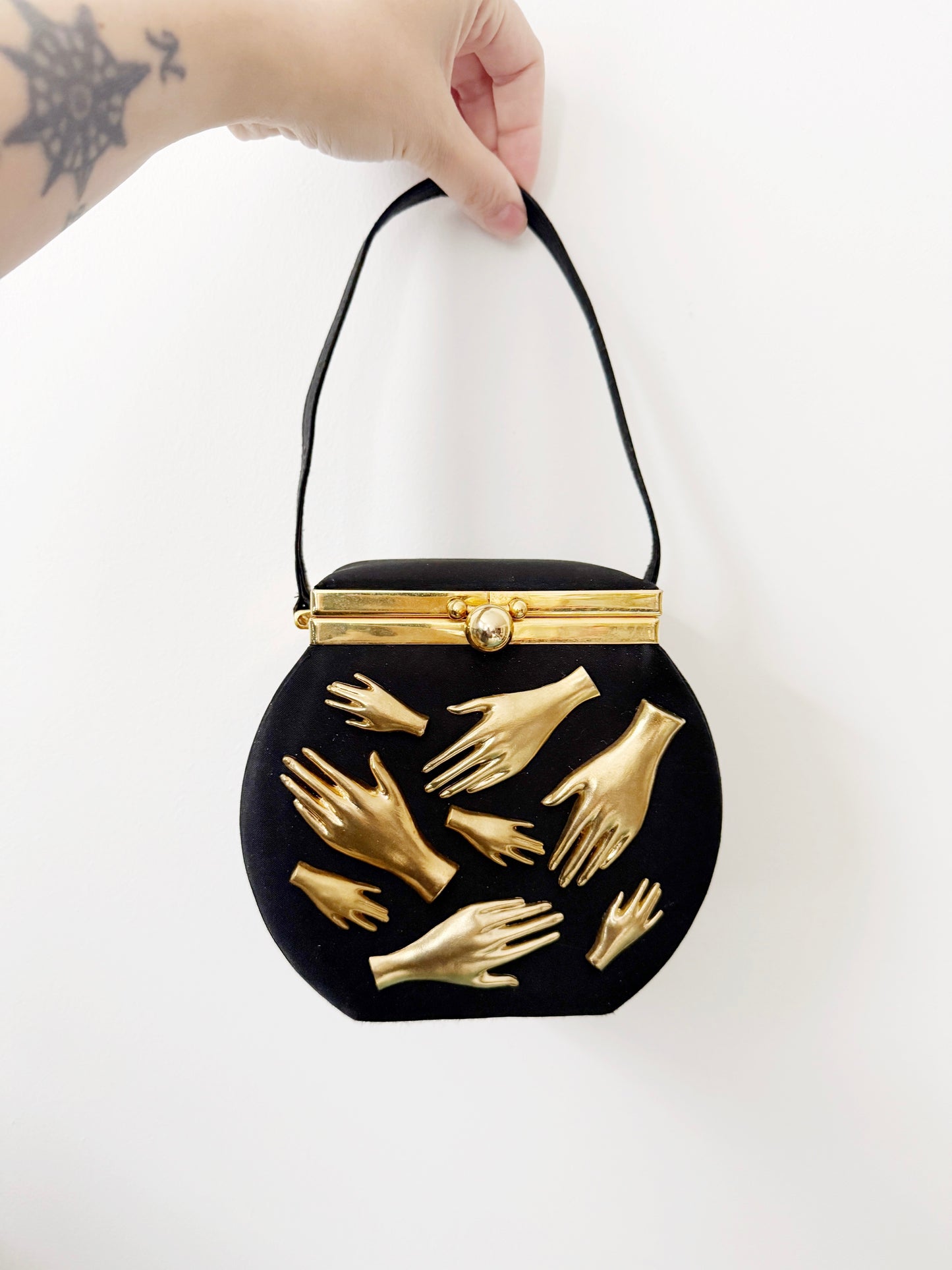 Gallery wall hands in purse