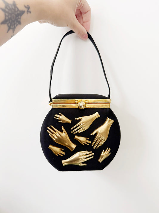 Gallery wall hands in purse