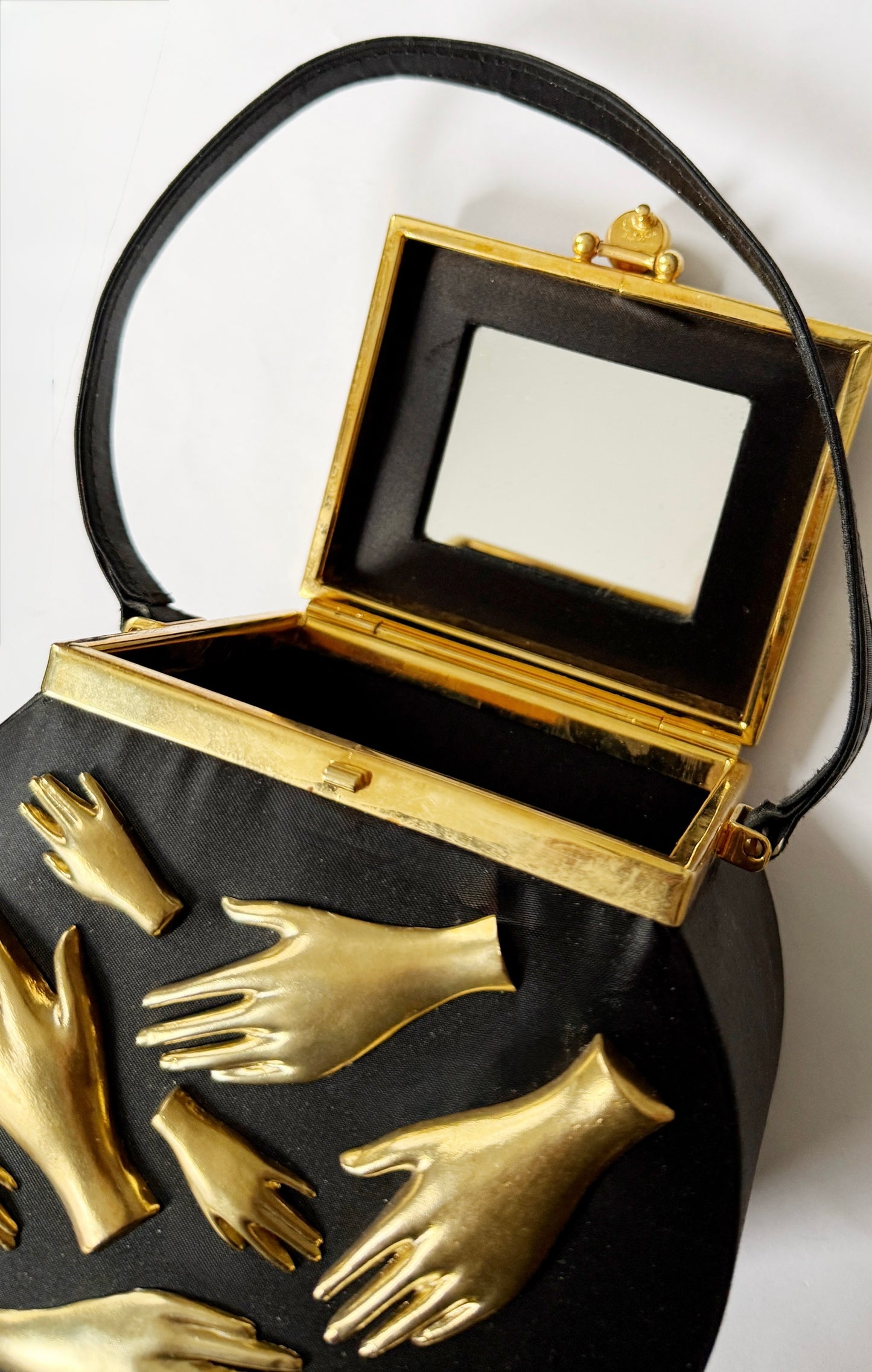 Gallery wall hands in purse