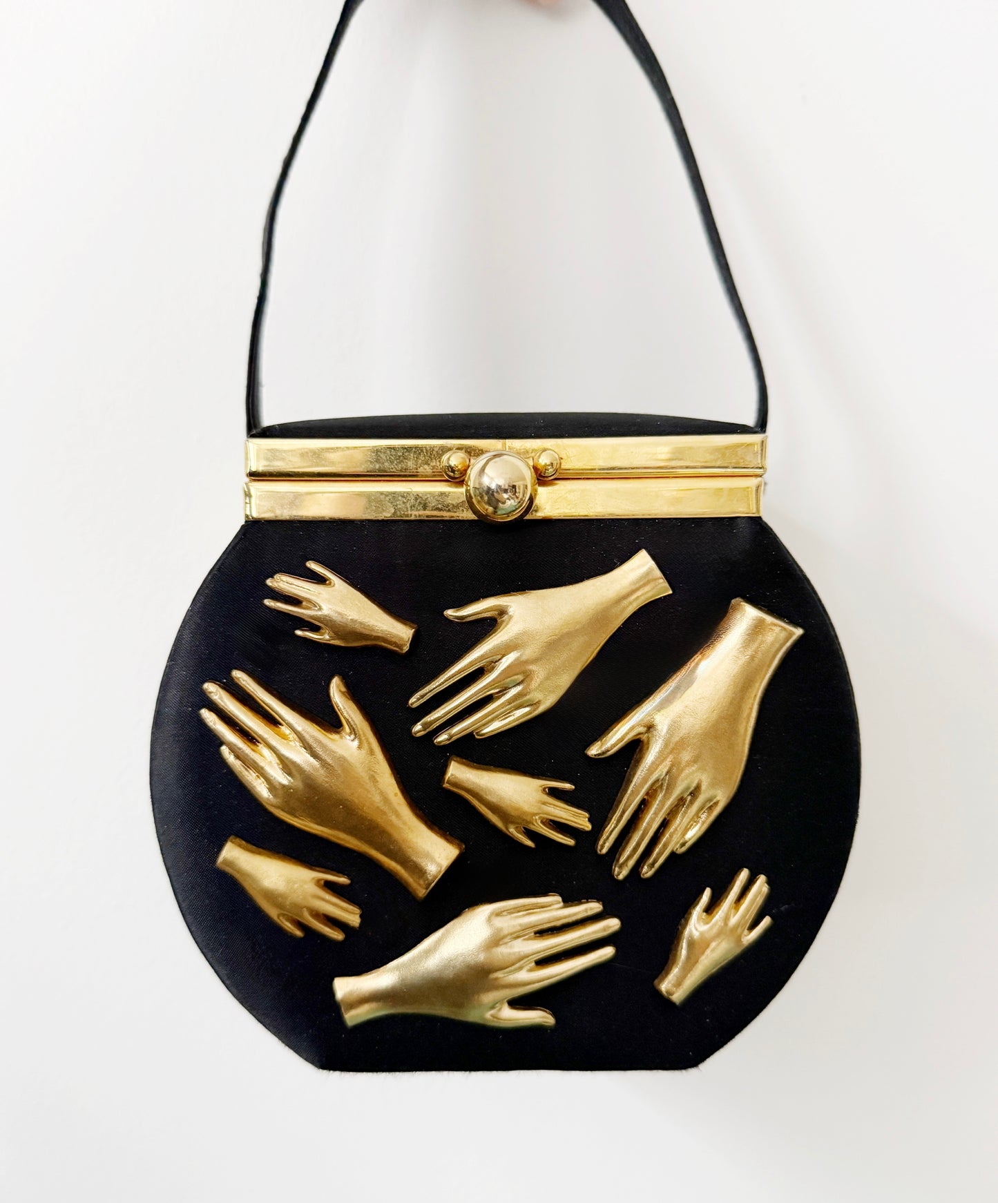 Gallery wall hands in purse